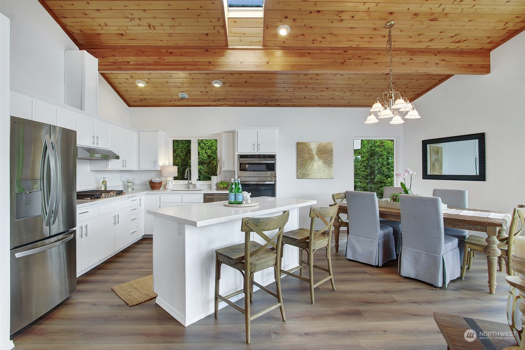 4824 Seahurst Avenue Everett, WA 98203 - Photo 9 of 33 a kitchen with a dining table chairs and refrigerator
