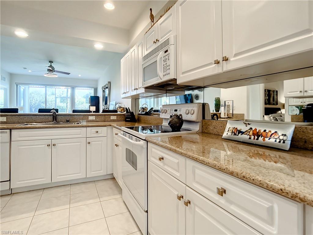 7930 Mahogany Run Lane, Unit 814 Naples, FL 34113 - Photo 11 of 29 a kitchen with cabinets and appliances