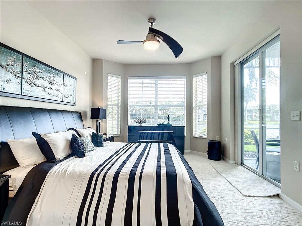 7930 Mahogany Run Lane, Unit 814 Naples, FL 34113 - Photo 16 of 29 a bedroom with a large bed and a large window