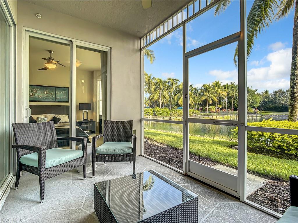 7930 Mahogany Run Lane, Unit 814 Naples, FL 34113 - Photo 17 of 29 a living room with couch and a floor to ceiling window