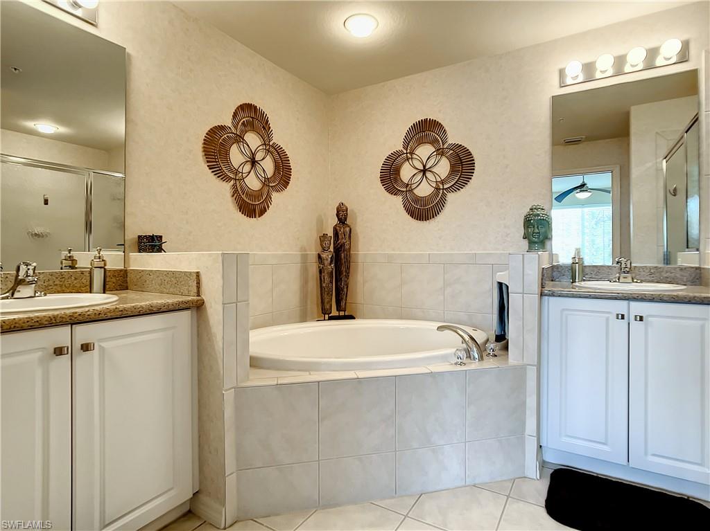 7930 Mahogany Run Lane, Unit 814 Naples, FL 34113 - Photo 19 of 29 a bathroom with a sink and a mirror