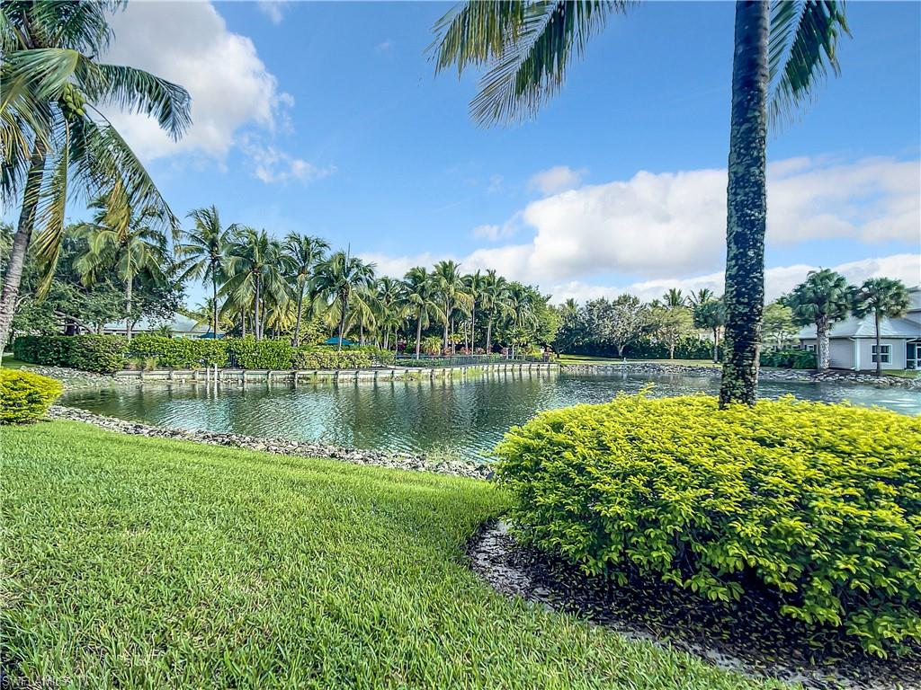 7930 Mahogany Run Lane, Unit 814 Naples, FL 34113 - Photo 2 of 29 a view of a lake with a big yard and palm trees