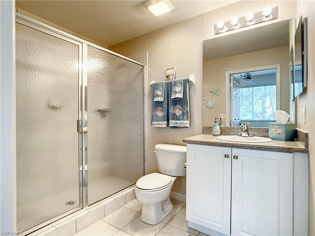 7930 Mahogany Run Lane, Unit 814 Naples, FL 34113 - Photo 23 of 29 a bathroom with a toilet sink and shower