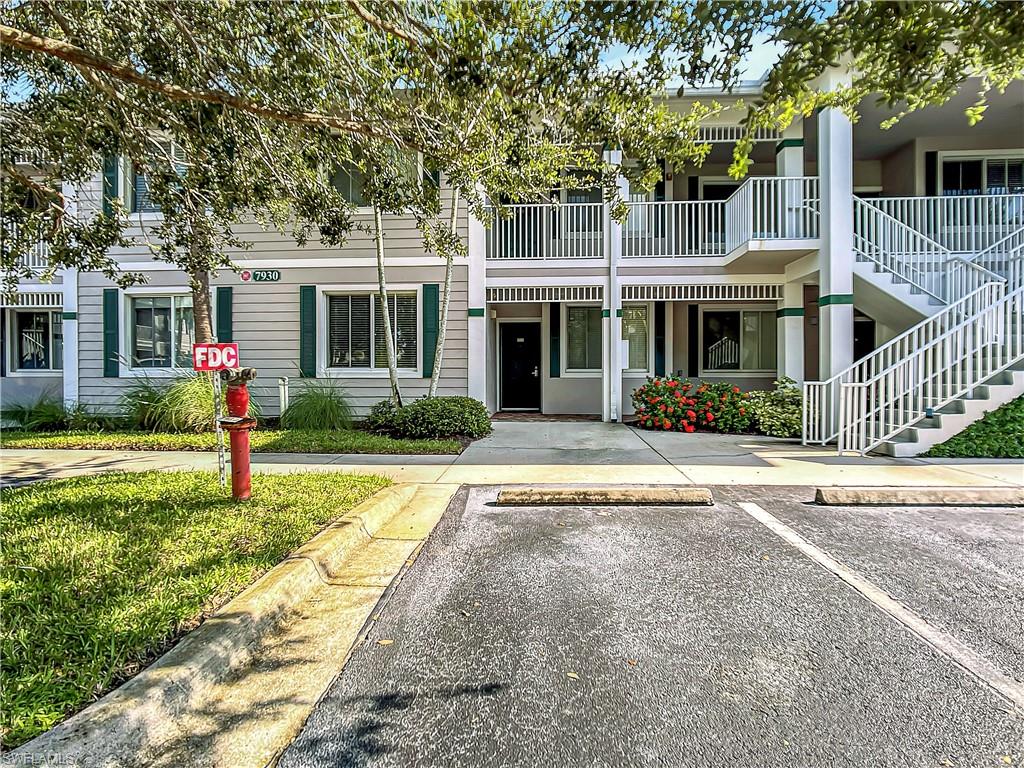 7930 Mahogany Run Lane, Unit 814 Naples, FL 34113 - Photo 26 of 29 a front view of a house with a yard