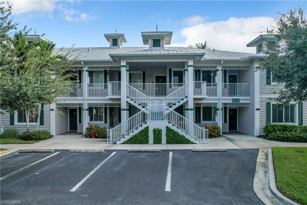7930 Mahogany Run Lane, Unit 814 Naples, FL 34113 - Photo 28 of 29 front view of a brick house with a yard