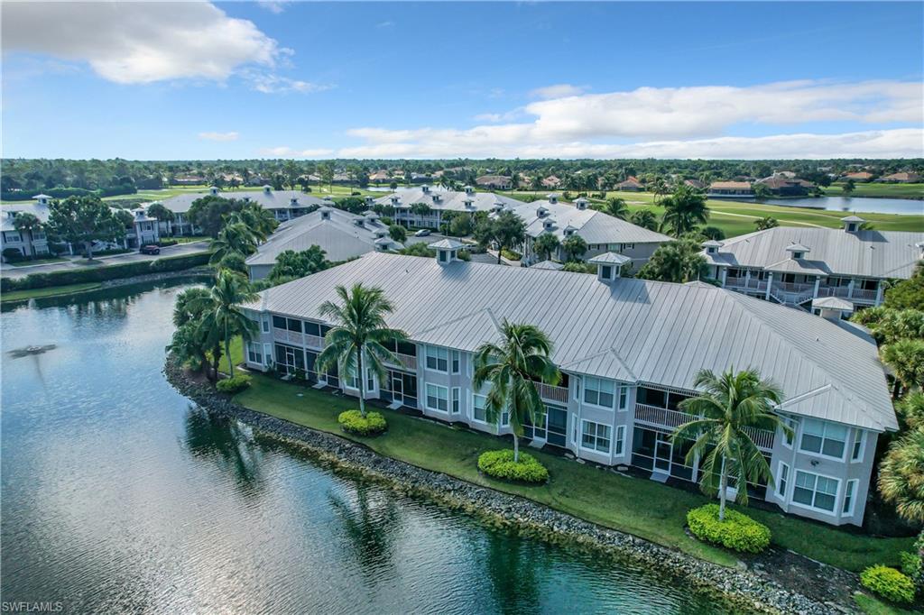 7930 Mahogany Run Lane, Unit 814 Naples, FL 34113 - Photo 29 of 29 a view of a house next to a lake with a city