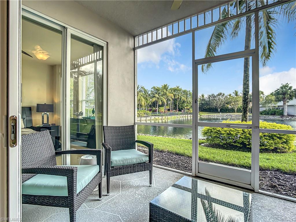 7930 Mahogany Run Lane, Unit 814 Naples, FL 34113 - Photo 3 of 29 a living room with glass windows and furniture