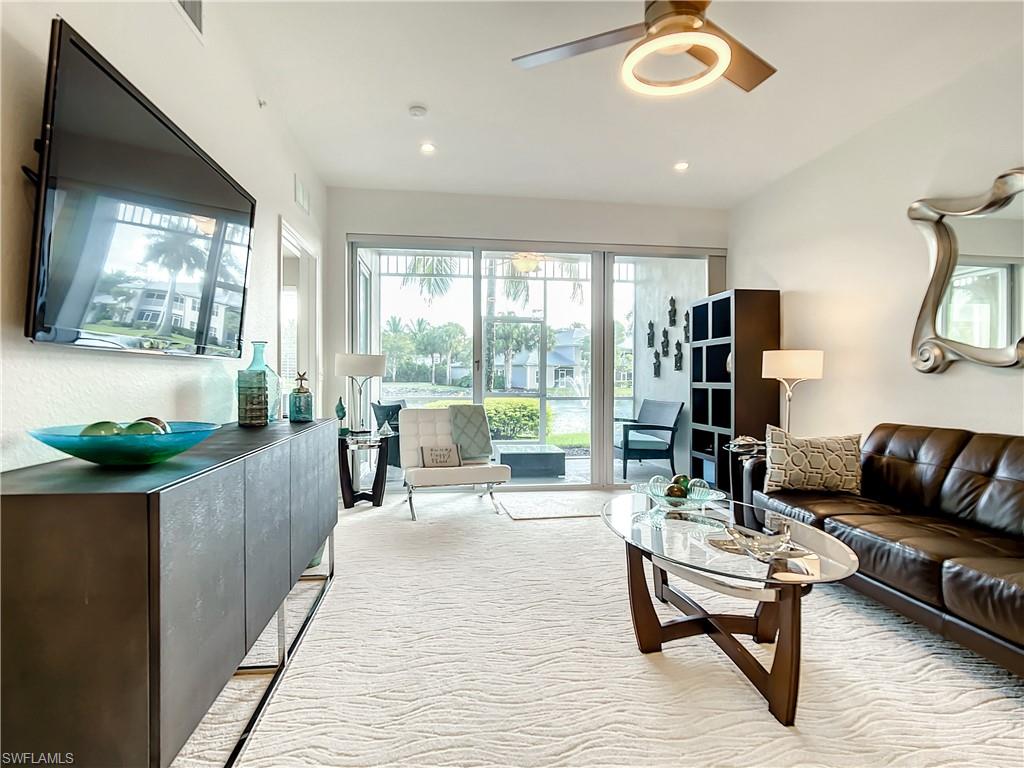 7930 Mahogany Run Lane, Unit 814 Naples, FL 34113 - Photo 6 of 29 a living room with furniture and a flat screen tv