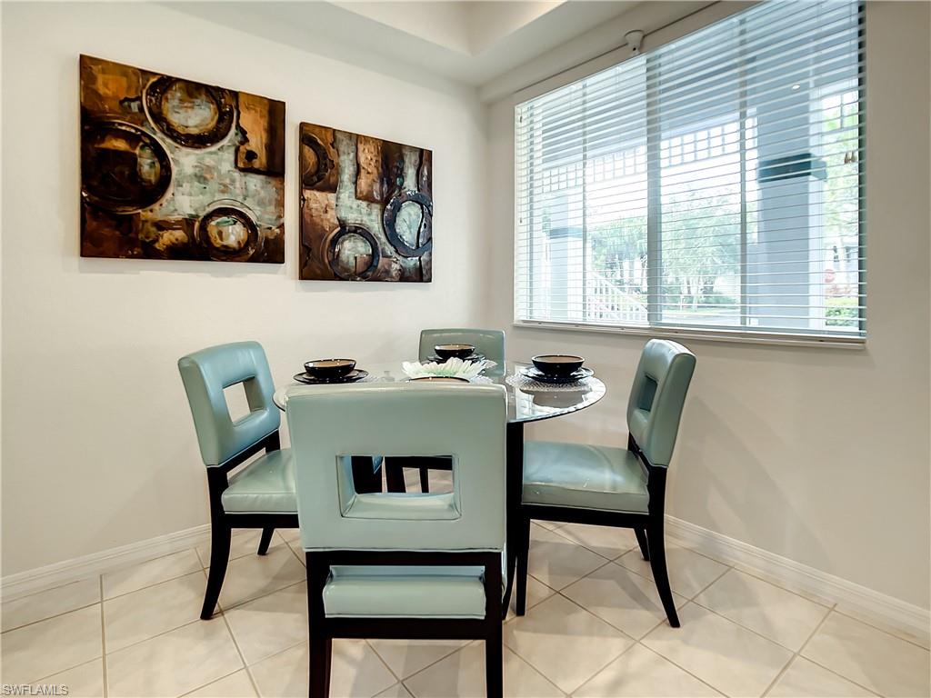 7930 Mahogany Run Lane, Unit 814 Naples, FL 34113 - Photo 8 of 29 a view of a dining room with furniture and window