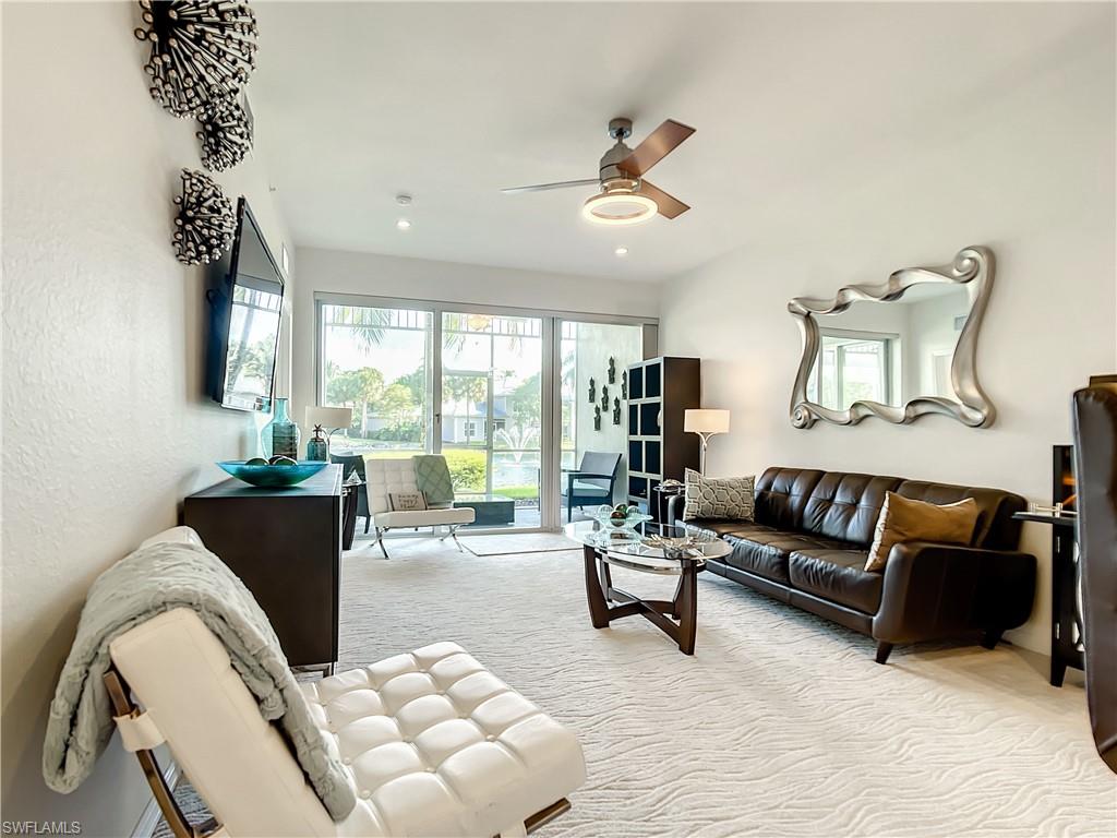 7930 Mahogany Run Lane, Unit 814 Naples, FL 34113 - Photo 10 of 29 a living room with furniture and a large window