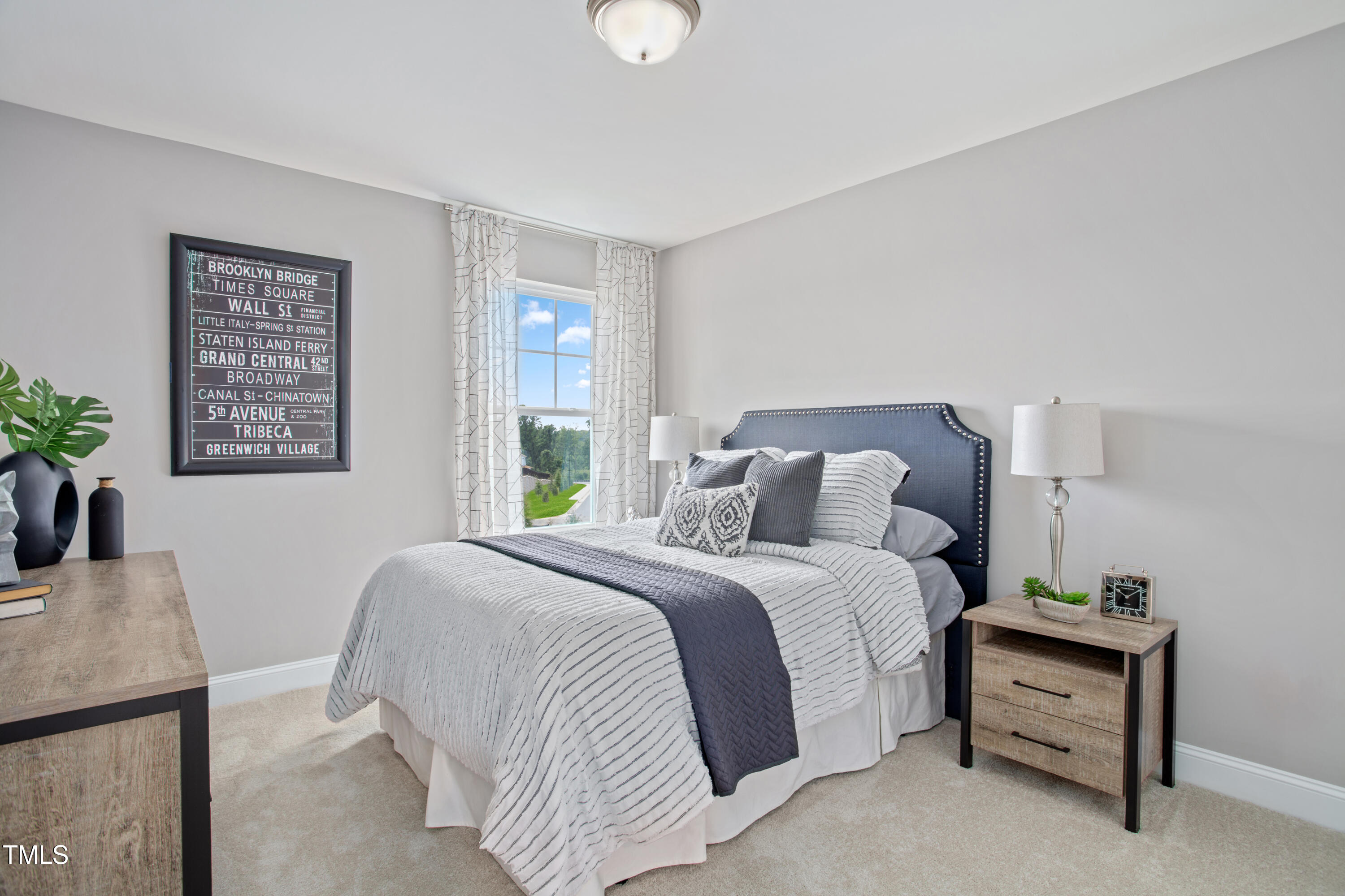 2011 Cross Bones Boulevard, Unit 41 Durham, NC 27703 - Photo 12 of 14 a bedroom with a bed and a table