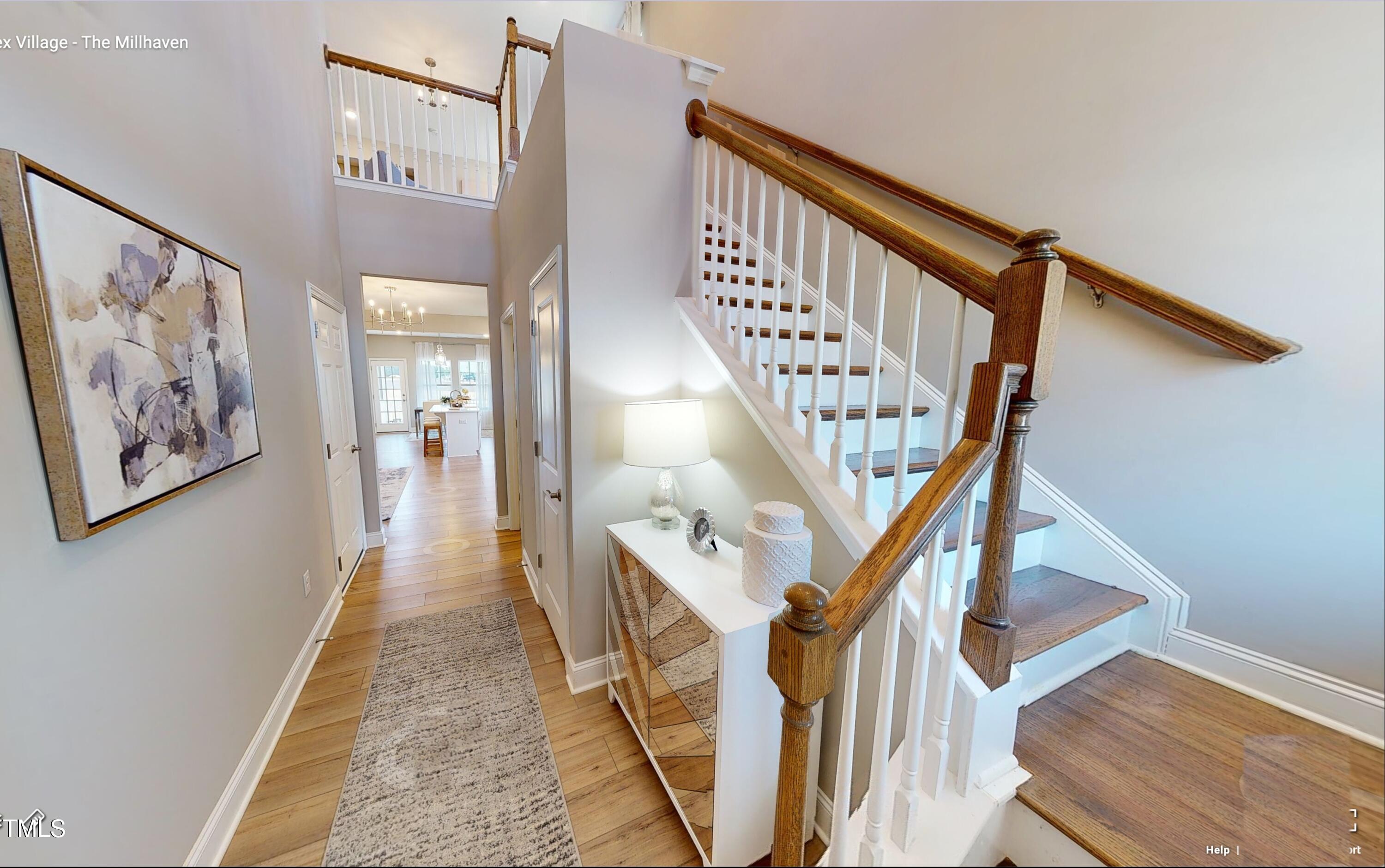 2011 Cross Bones Boulevard, Unit 41 Durham, NC 27703 - Photo 2 of 14 a view of staircase with lots of frames on wall and wooden floor