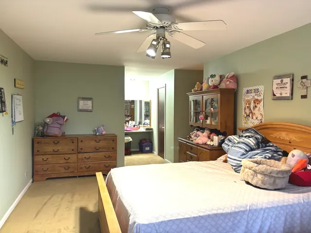 a bedroom with a bed and ceiling fan