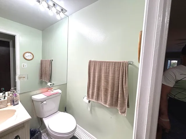 a white toilet sitting next to a bathroom sink