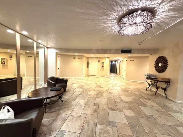 a living room with furniture and a chandelier