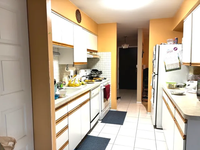 a kitchen with a refrigerator and a stove