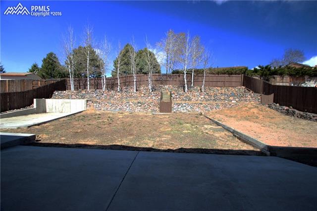 5224 Rondo Way Colorado Springs, CO 80911 - Photo 35 of 36 Back yard view from the walkout. Tiered back yard has a rock platform on the upper right for another picnic area.
