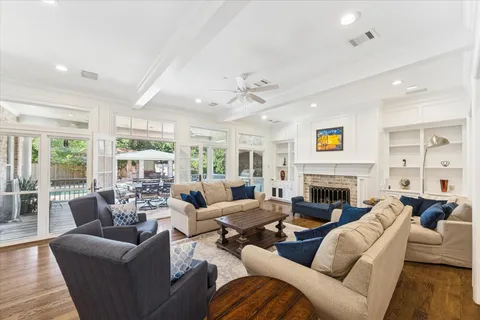 a living room with furniture fireplace and a large window