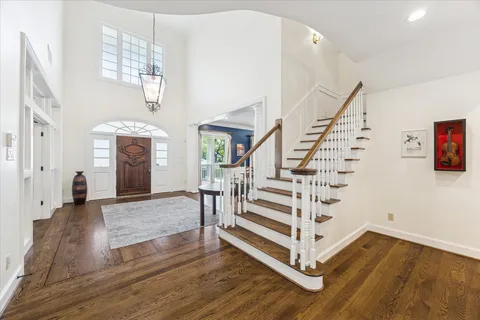 a view of entryway and hall with wooden floor