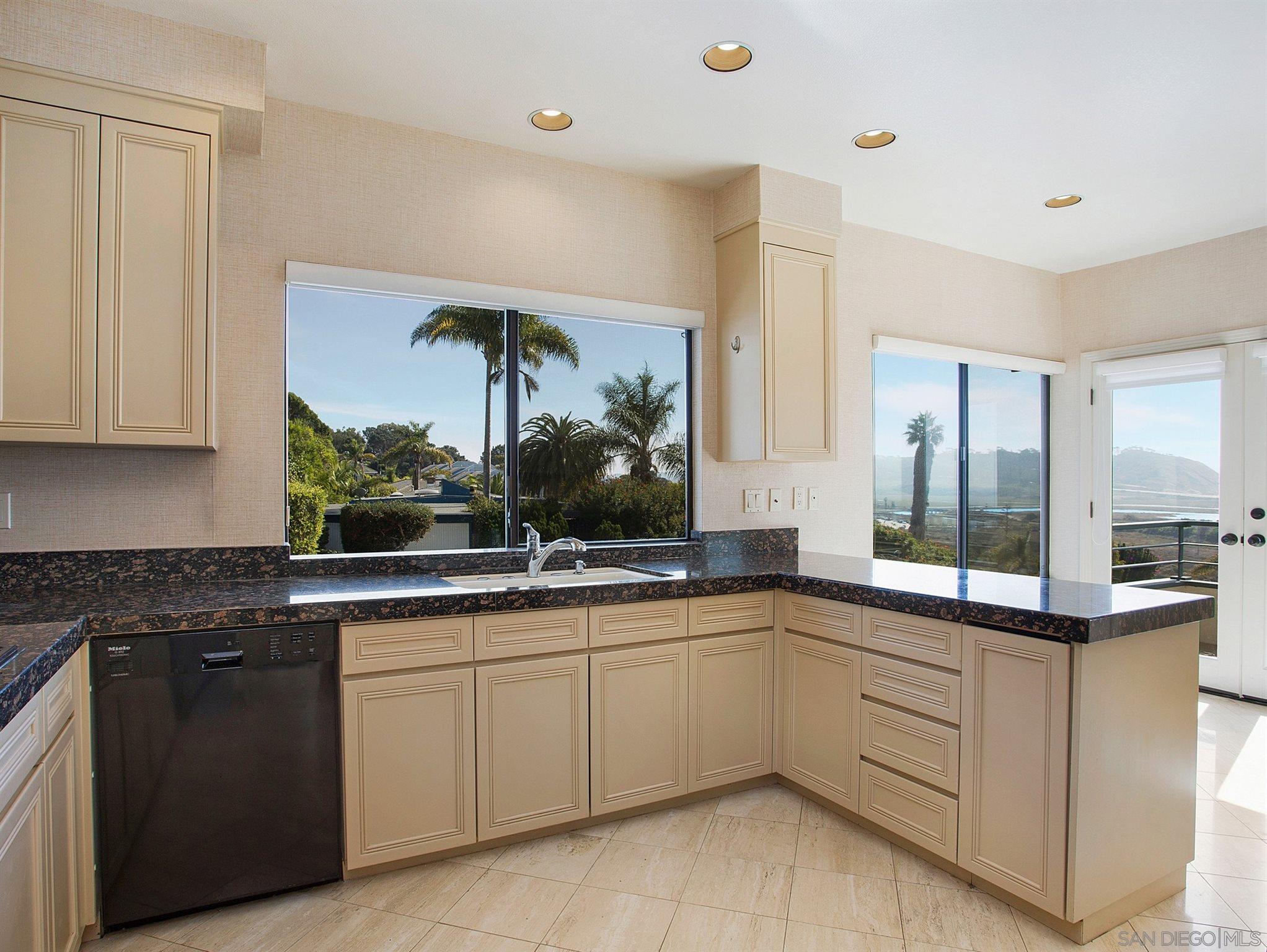 560 Torrey Point Road Del Mar, CA 92014 - Photo 9 of 25 a kitchen with a sink and cabinets