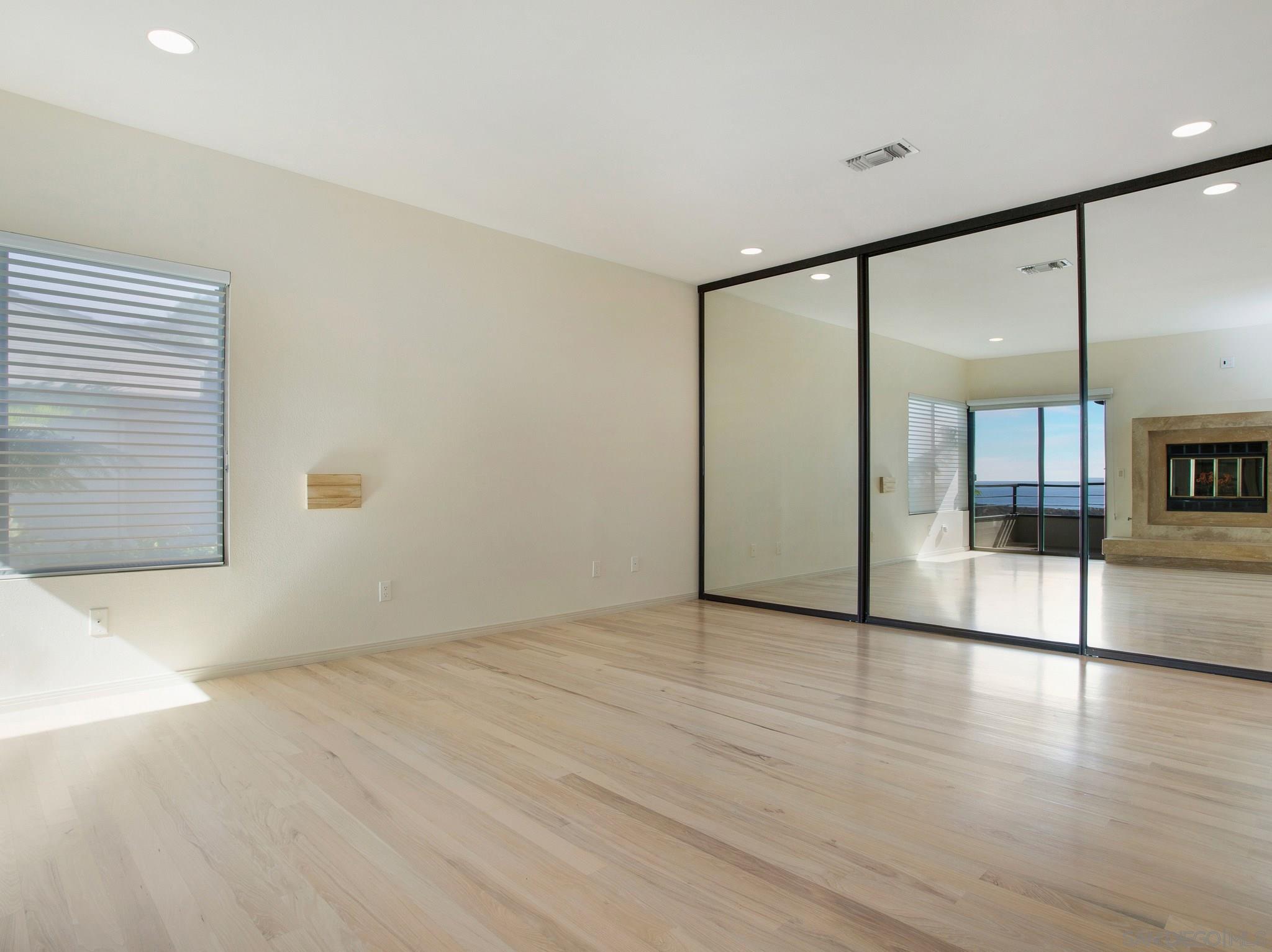 560 Torrey Point Road Del Mar, CA 92014 - Photo 10 of 25 an empty room with wooden floor and windows