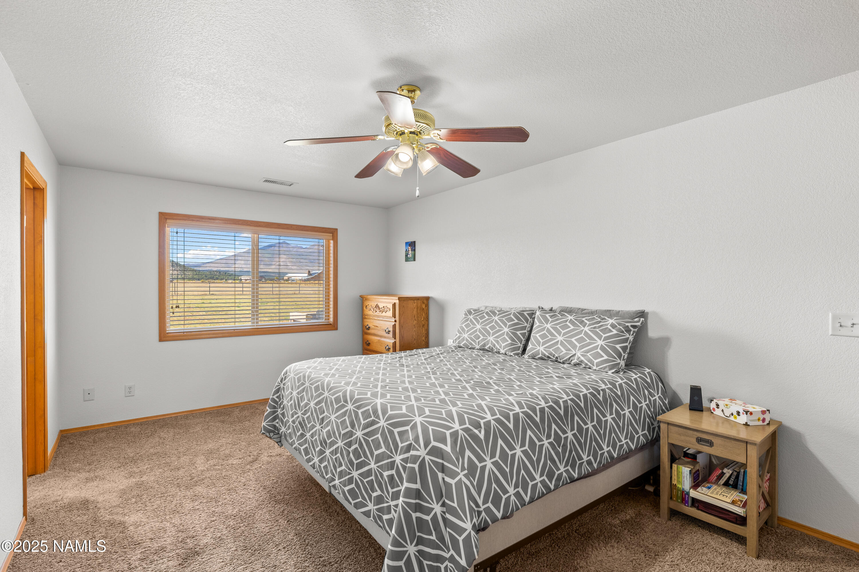 9662 North Aldrich Road Flagstaff, AZ 86004 - Photo 13 of 33 a bedroom with a bed and a chandelier
