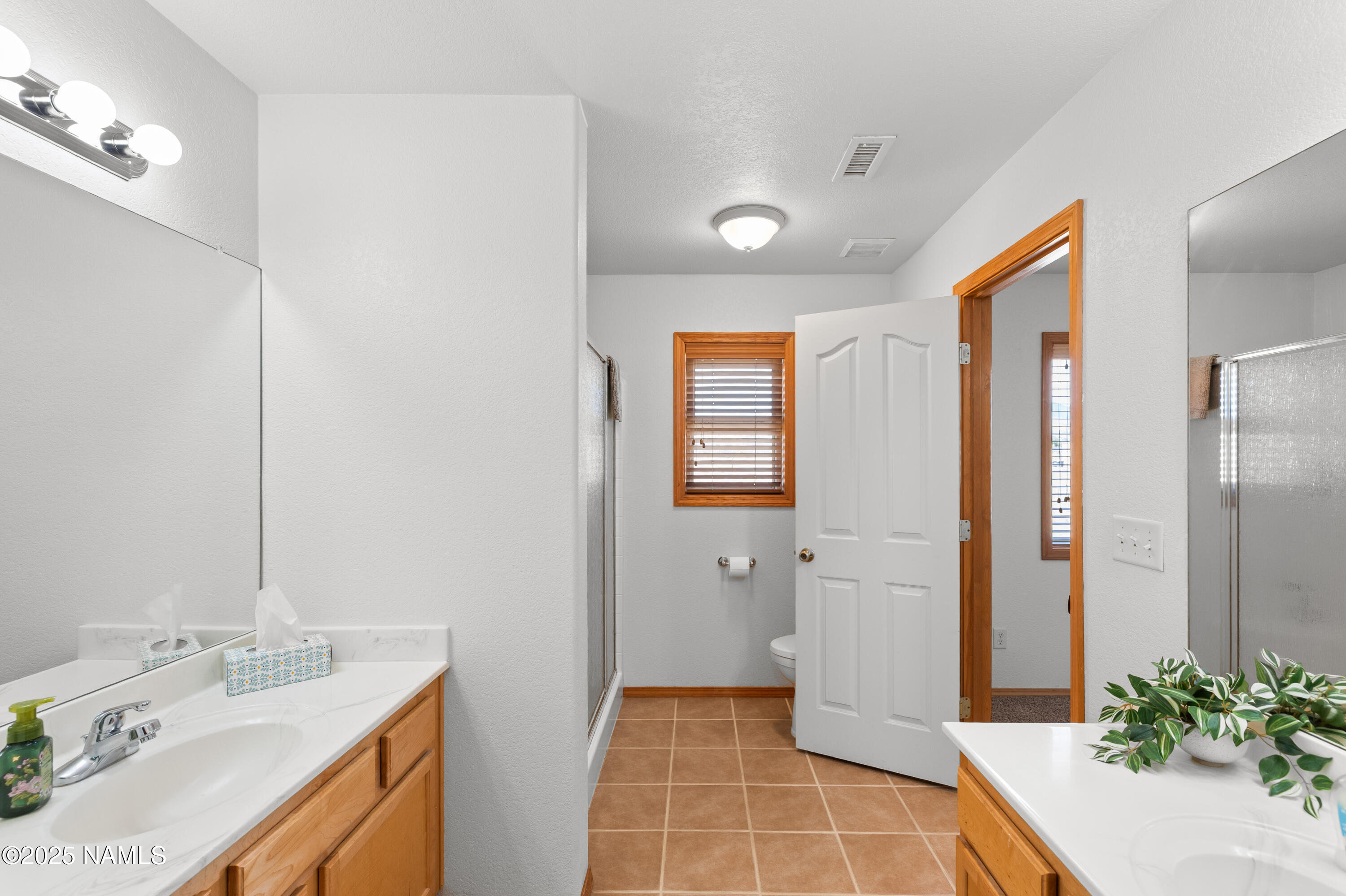 9662 North Aldrich Road Flagstaff, AZ 86004 - Photo 15 of 33 a bathroom with a double vanity sink and mirror