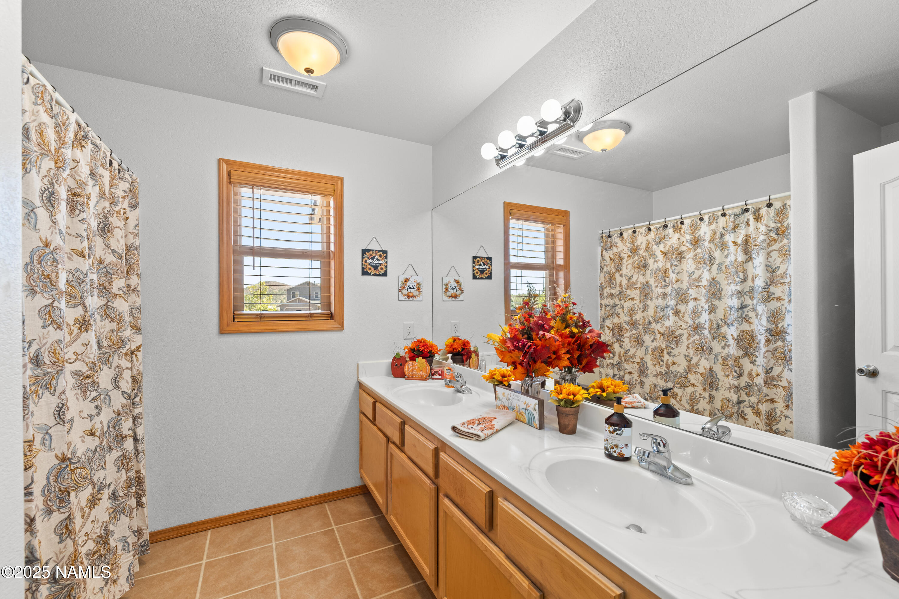 9662 North Aldrich Road Flagstaff, AZ 86004 - Photo 20 of 33 a bathroom with a sink vanity and a mirror