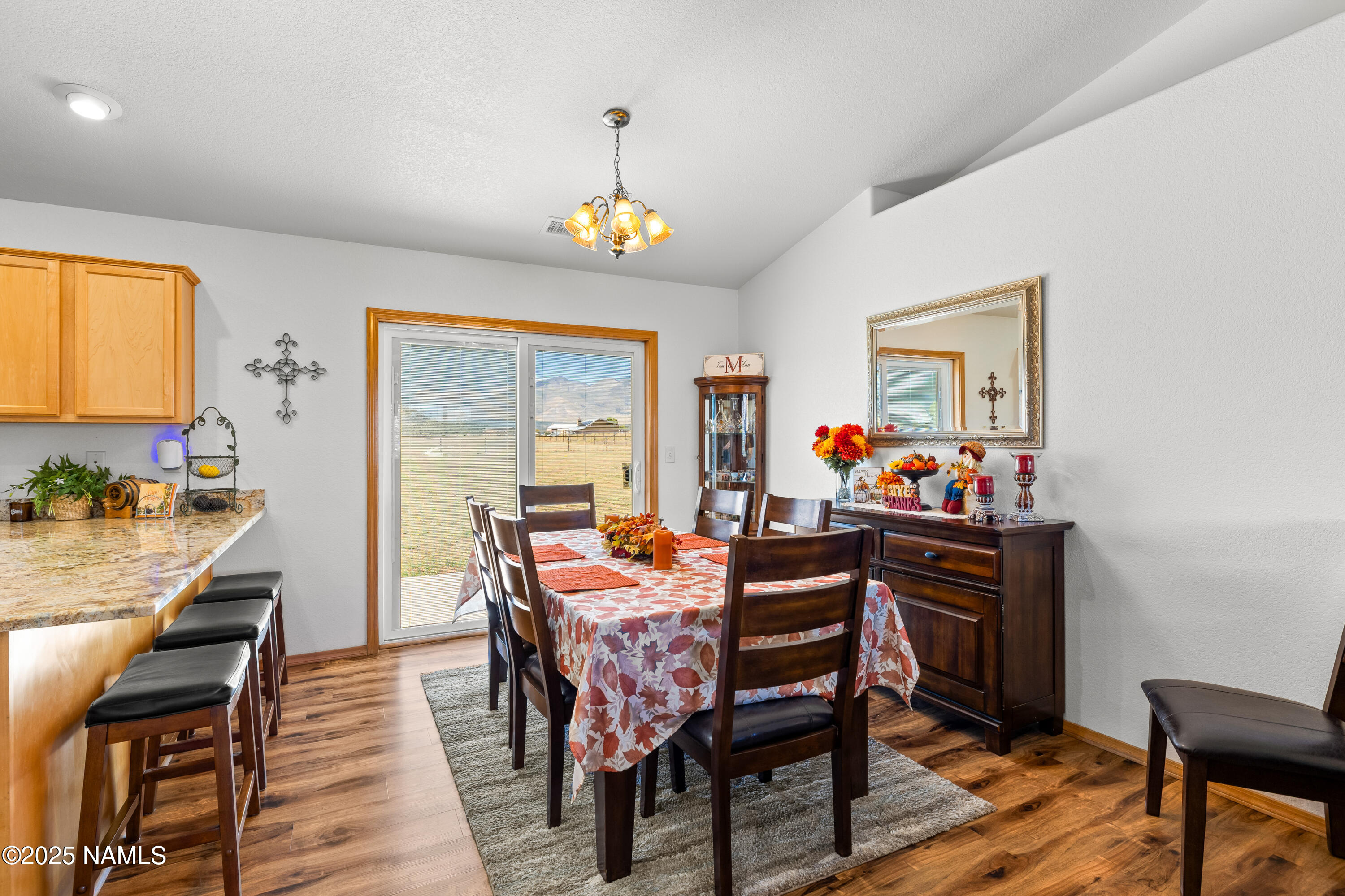 9662 North Aldrich Road Flagstaff, AZ 86004 - Photo 6 of 33 a dining room with furniture a rug and a chandelier