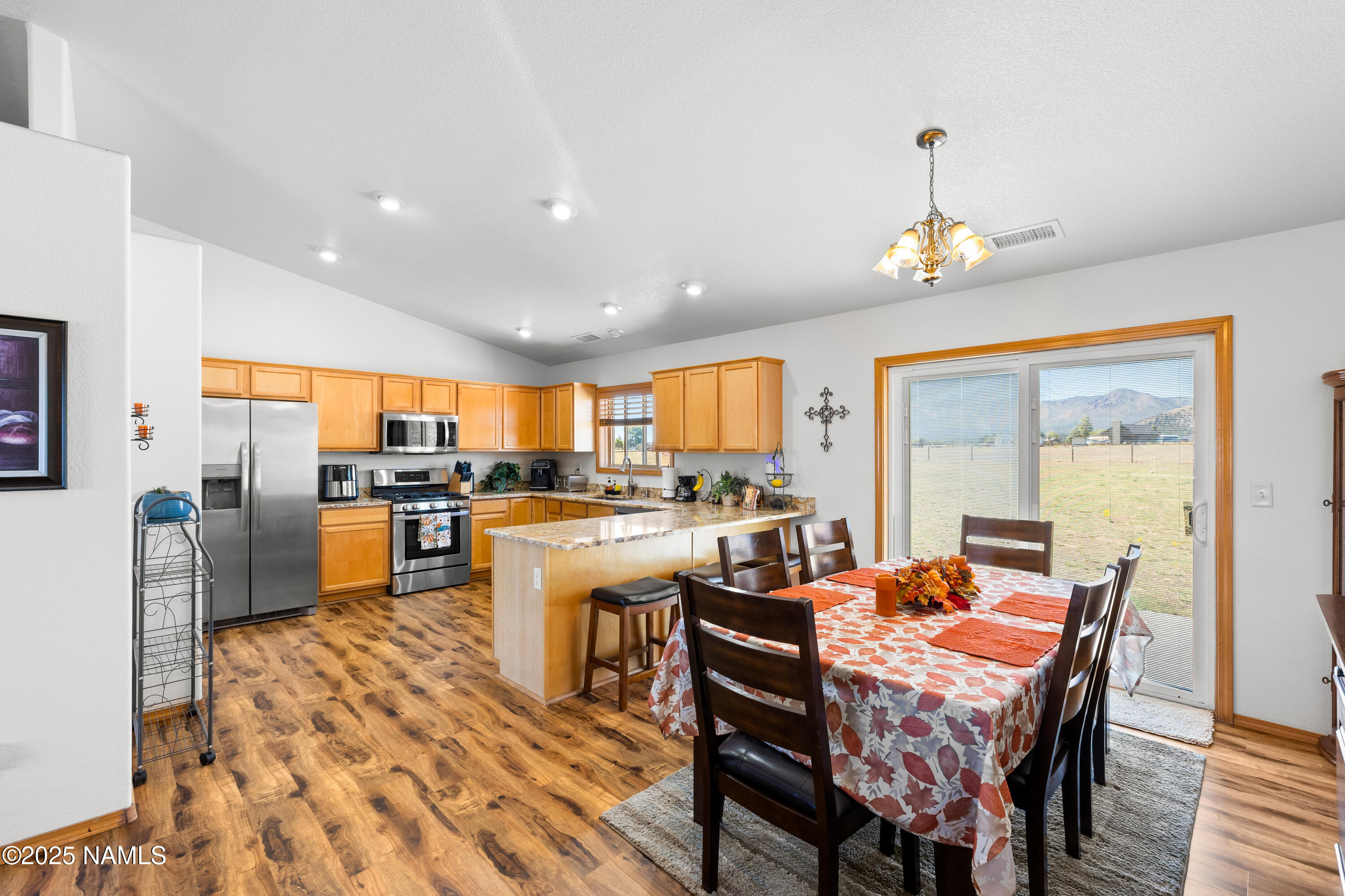9662 North Aldrich Road Flagstaff, AZ 86004 - Photo 7 of 33 a dining room with stainless steel appliances a dining table and chairs