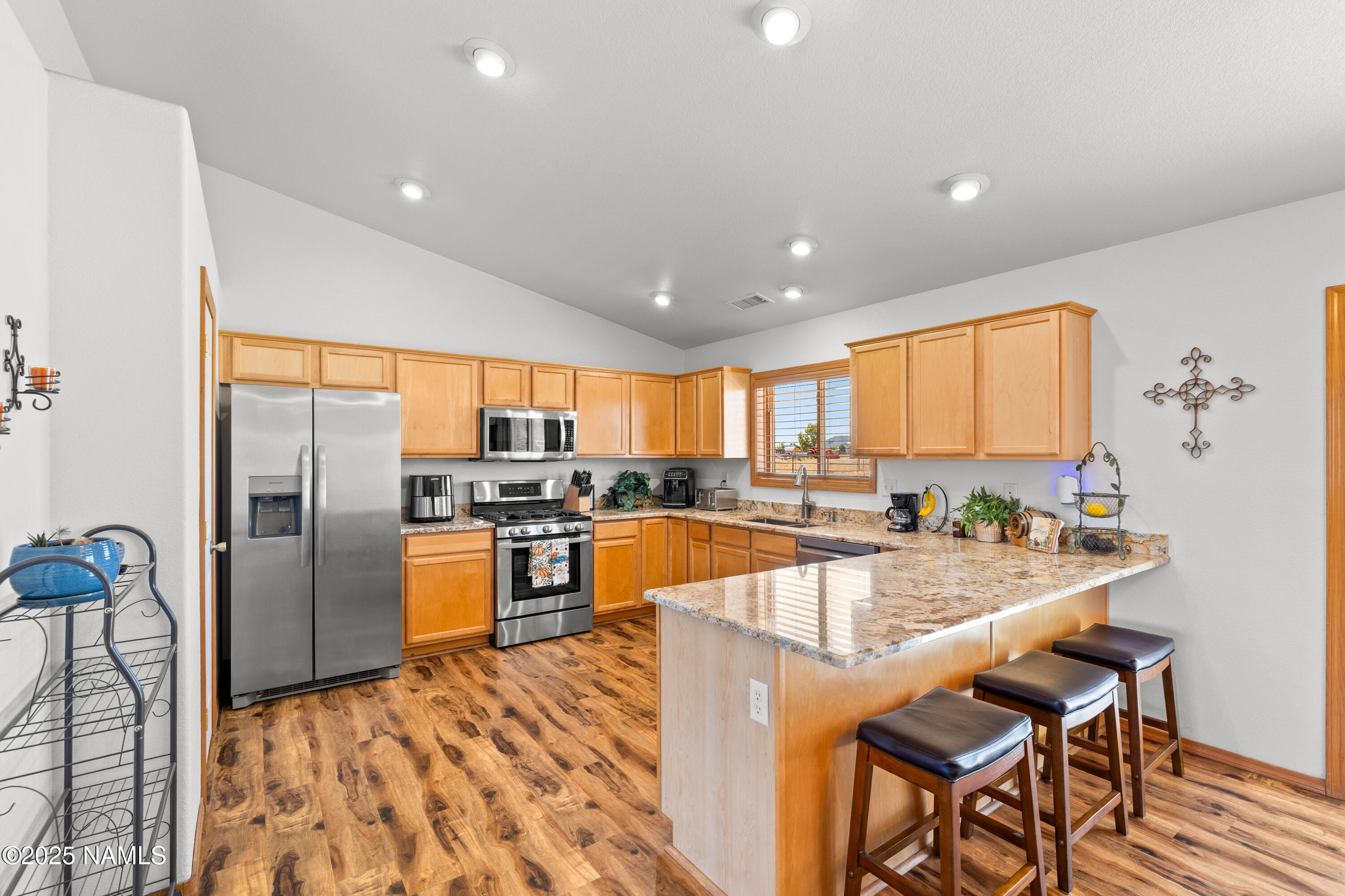 9662 North Aldrich Road Flagstaff, AZ 86004 - Photo 8 of 33 a large kitchen with granite countertop lots of counter space and stainless steel appliances