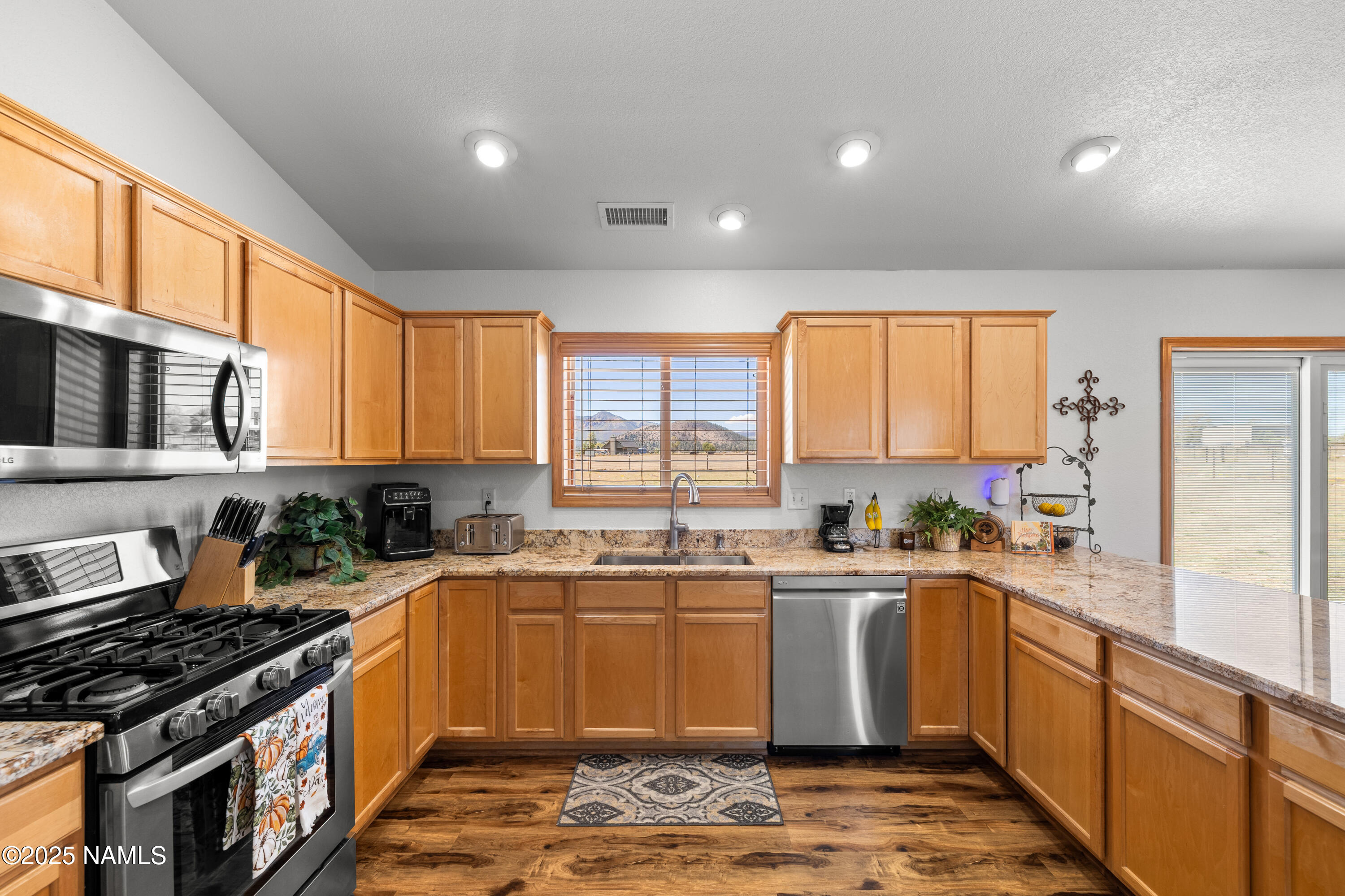 9662 North Aldrich Road Flagstaff, AZ 86004 - Photo 9 of 33 a kitchen with a sink stove top oven and cabinets