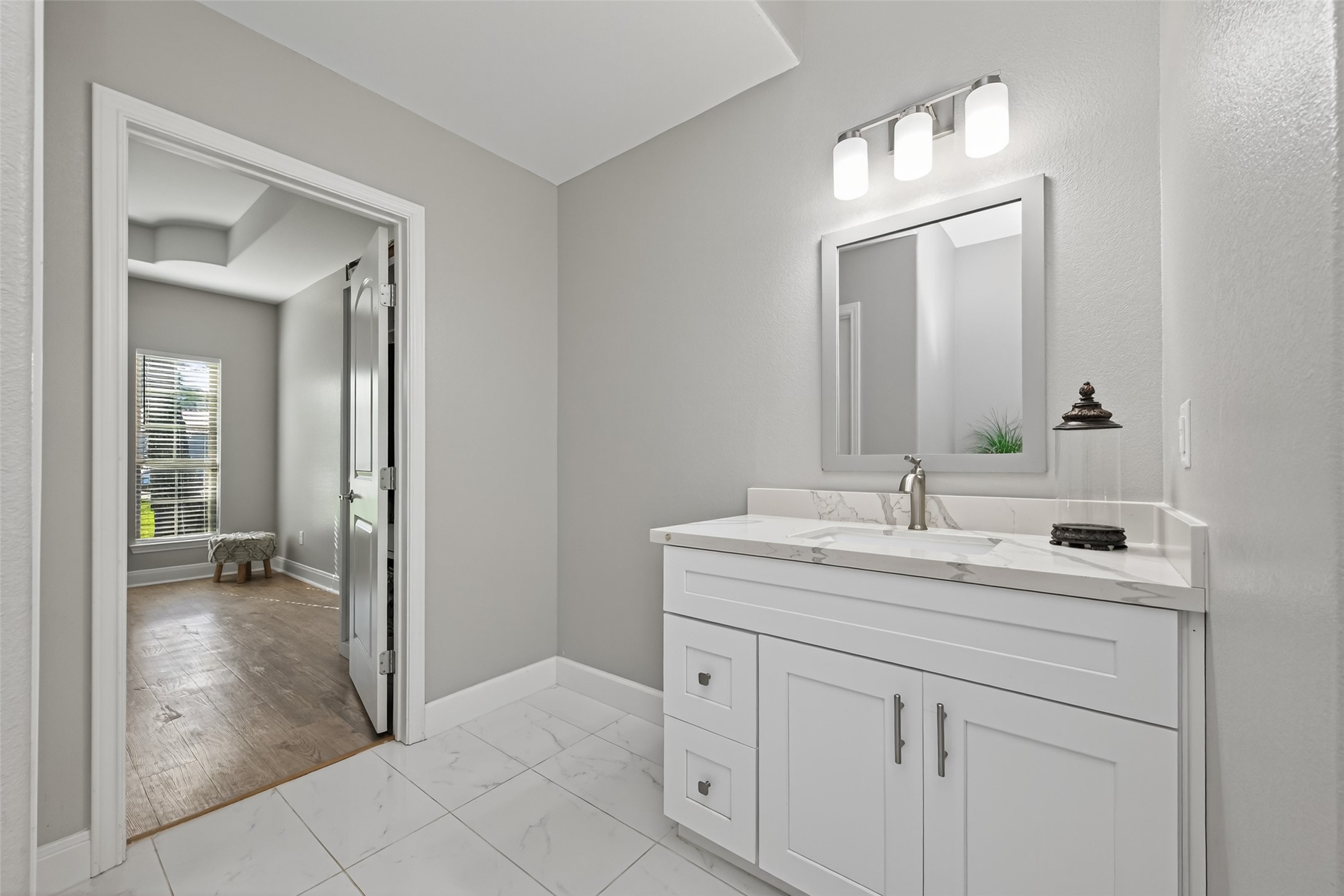 19477 Lazy Lane Porter, TX 77365 - Photo 11 of 26 a en suite bathroom with a sink a mirror and a shower