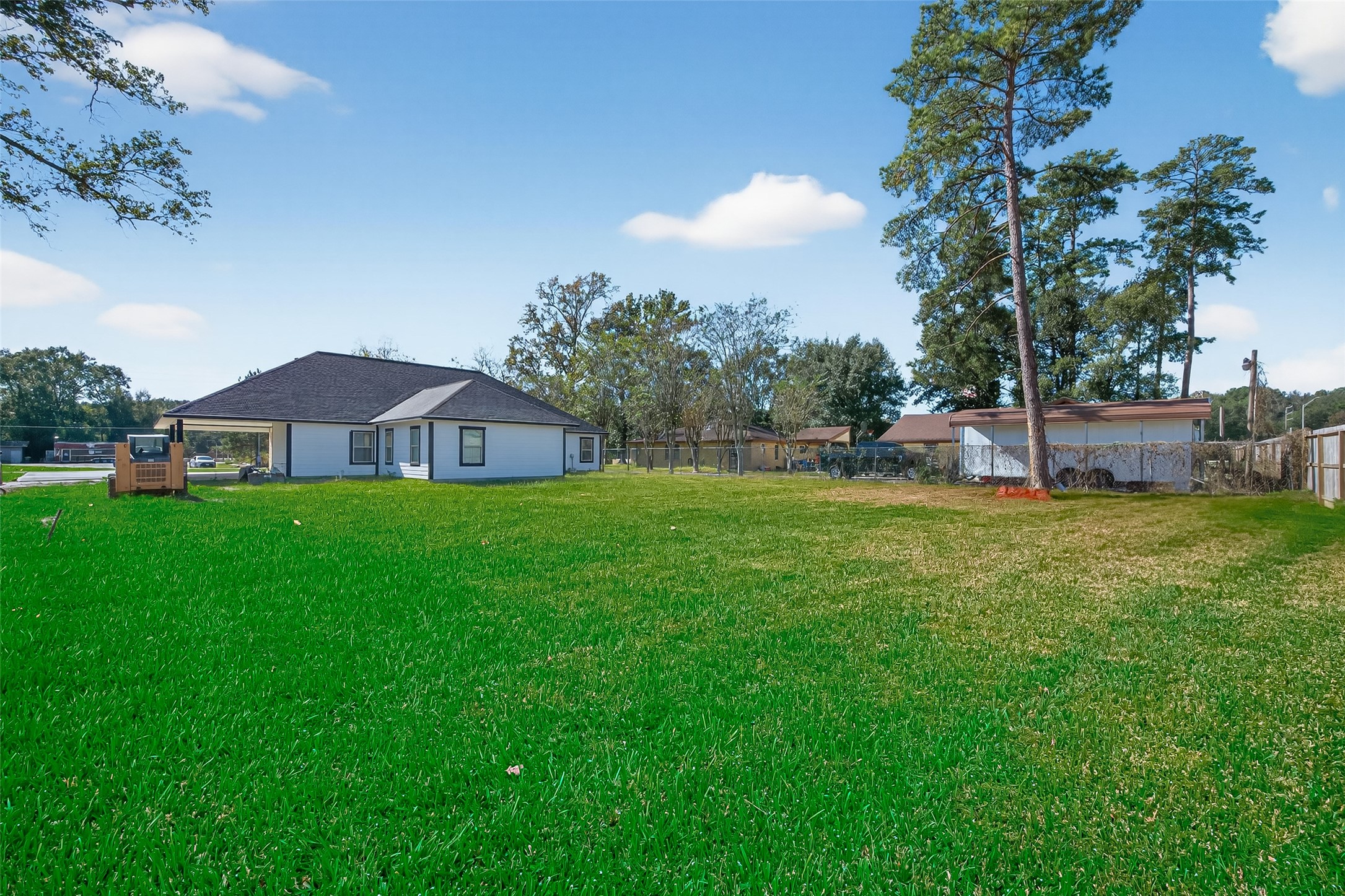 19477 Lazy Lane Porter, TX 77365 - Photo 23 of 26 a view of a house with a small yard and a palm tree