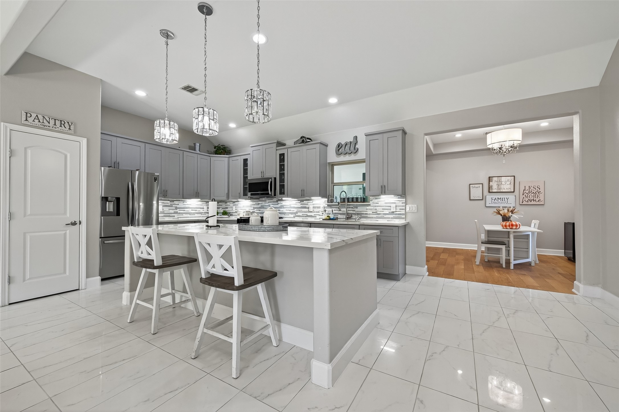 19477 Lazy Lane Porter, TX 77365 - Photo 6 of 26 a large kitchen with a table and chairs