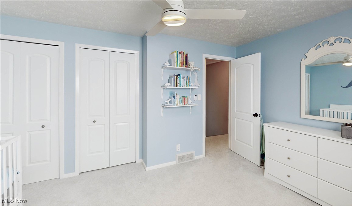 35600 Bainbridge Road Solon, OH 44139 - Photo 11 of 18 Carpeted bedroom featuring ceiling fan, and two closets