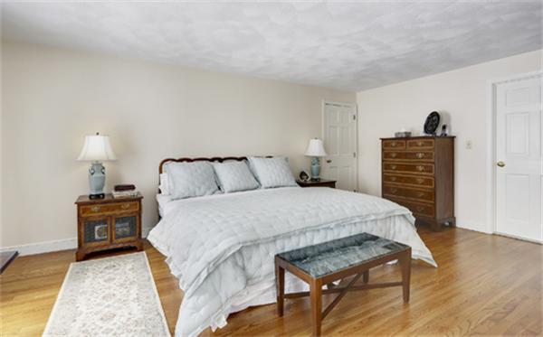 50 Sawmill Road North Andover, MA 01845 - Photo 14 of 25 a bedroom with a bed and wooden floor