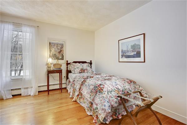 50 Sawmill Road North Andover, MA 01845 - Photo 18 of 25 a bedroom with a bed and a chair