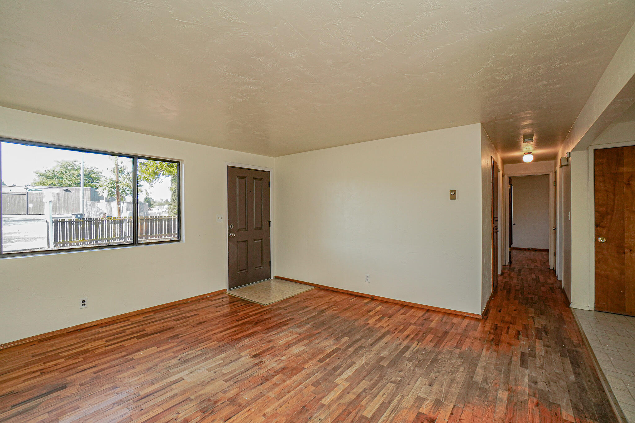 2540 Merriman Road Medford, OR 97501 - Photo 4 of 15 Living room with woodburning fireplace and original hardwood floors.