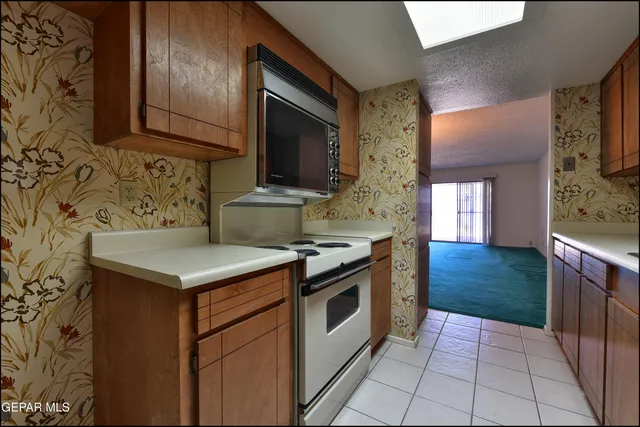 a kitchen with a stove and a microwave