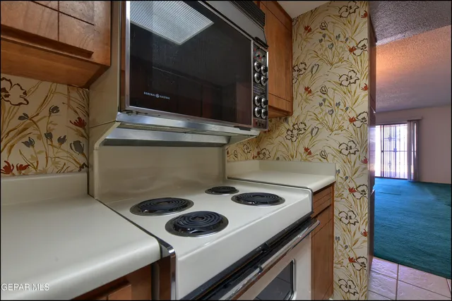 a stove top oven sitting inside of a kitchen