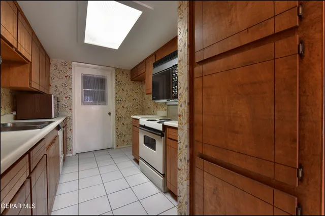 a kitchen with a sink stove and cabinets