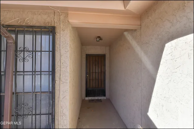 a view of a hallway with wooden walls and entryway