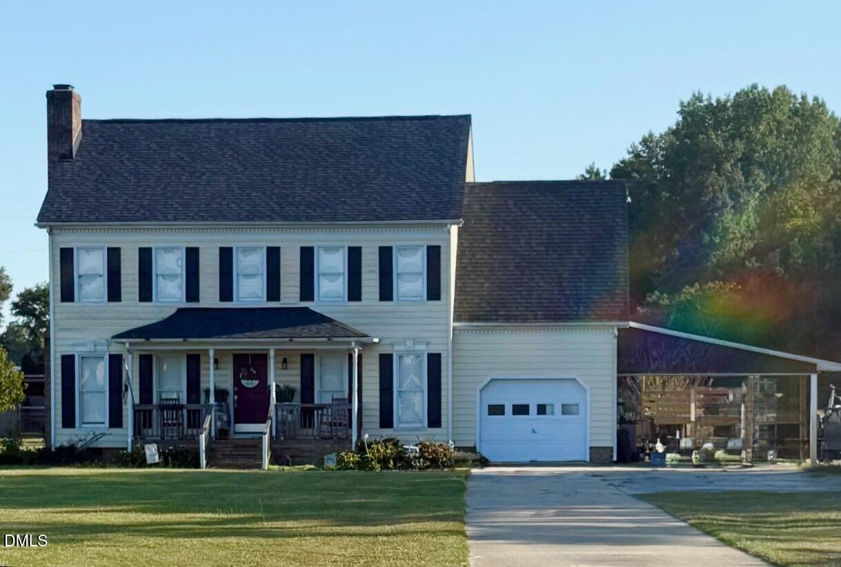 a front view of a building with a garden
