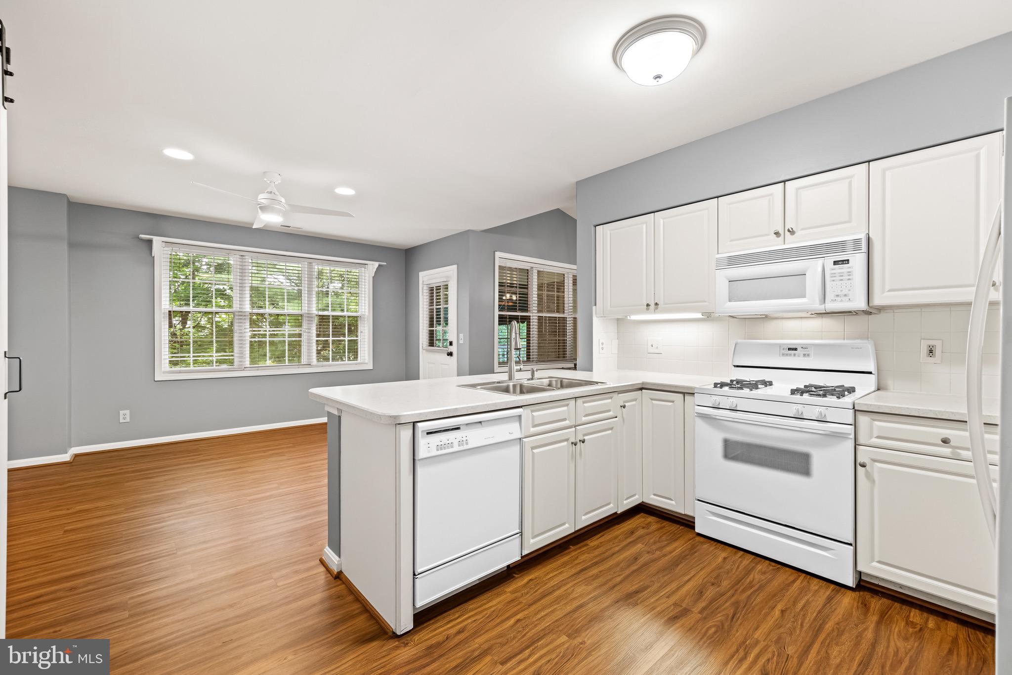 12204 Burncourt Road, Unit 302 Lutherville-Timonium, MD 21093 - Photo 11 of 27 a kitchen with stainless steel appliances granite countertop a stove and white cabinets