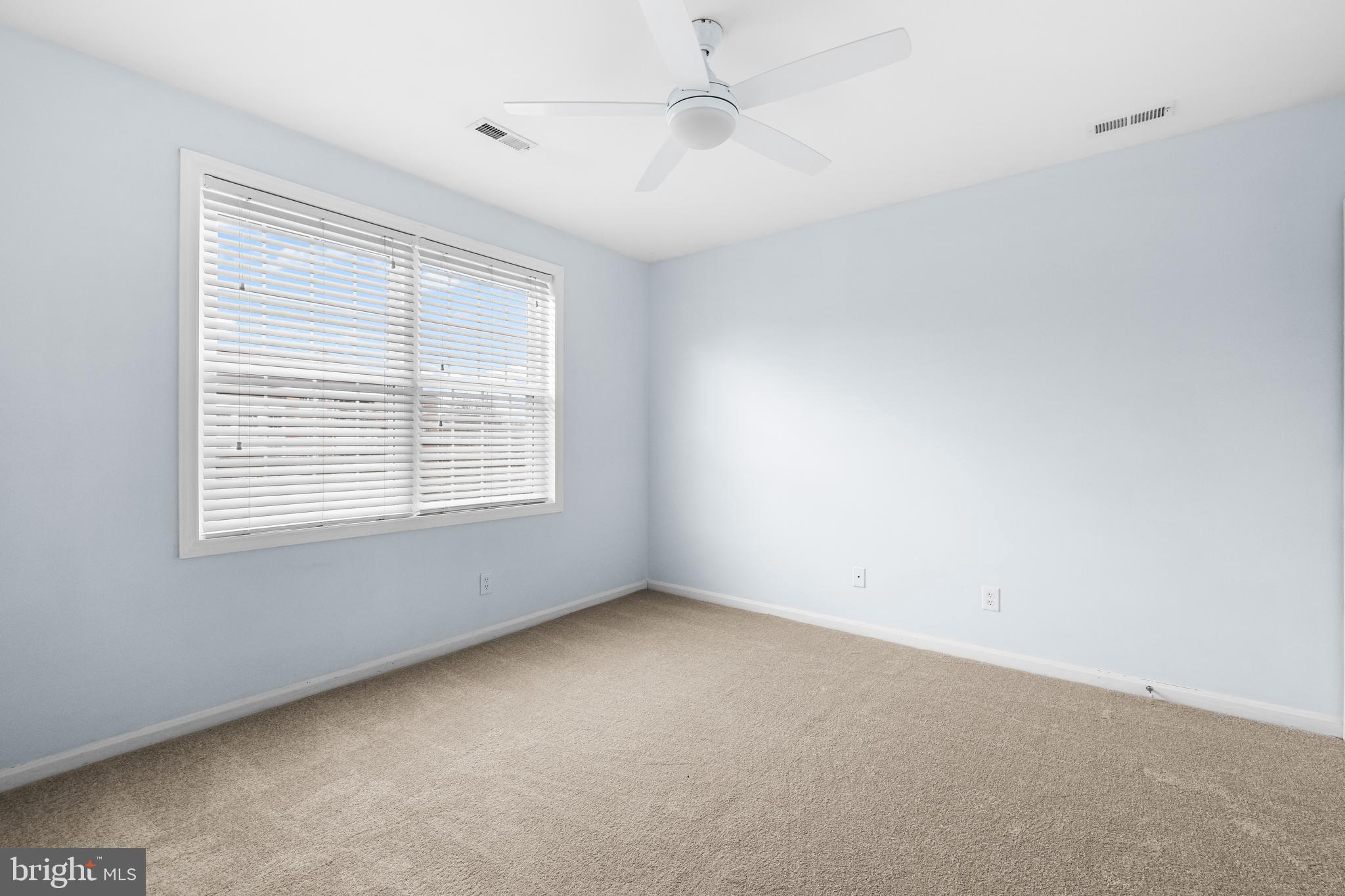 12204 Burncourt Road, Unit 302 Lutherville-Timonium, MD 21093 - Photo 16 of 27 an empty room with a window and a ceiling fan