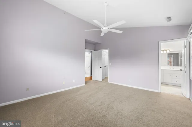 a view of an empty room with a ceiling fan