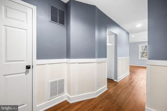 a view of walk in closet with wooden floor