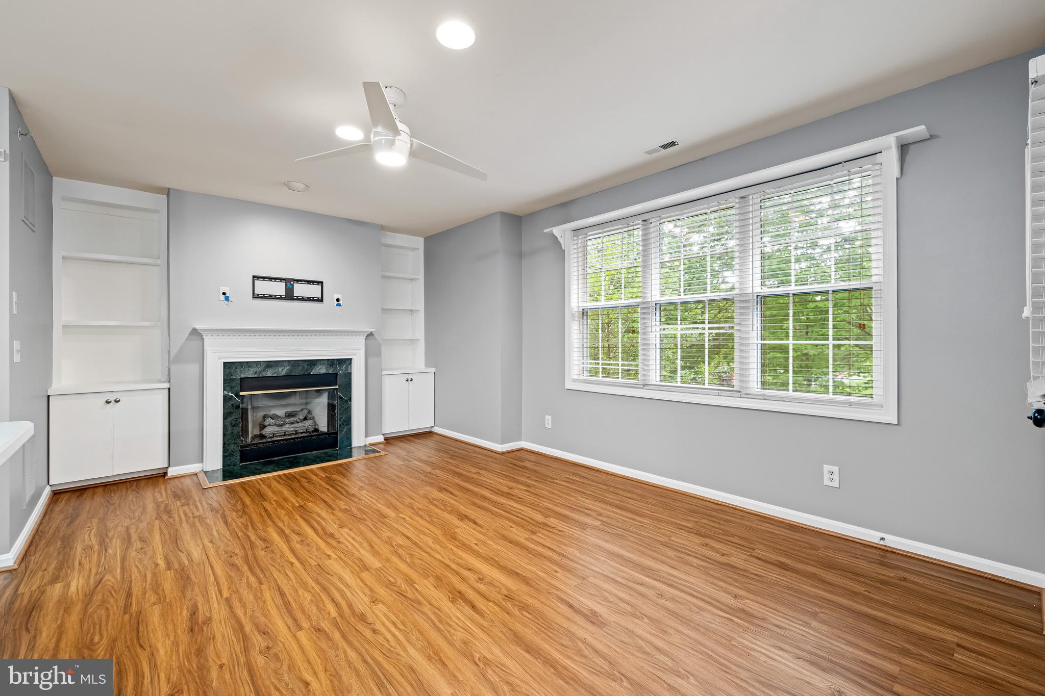 12204 Burncourt Road, Unit 302 Lutherville-Timonium, MD 21093 - Photo 6 of 27 a view of an empty room with a fireplace and a window