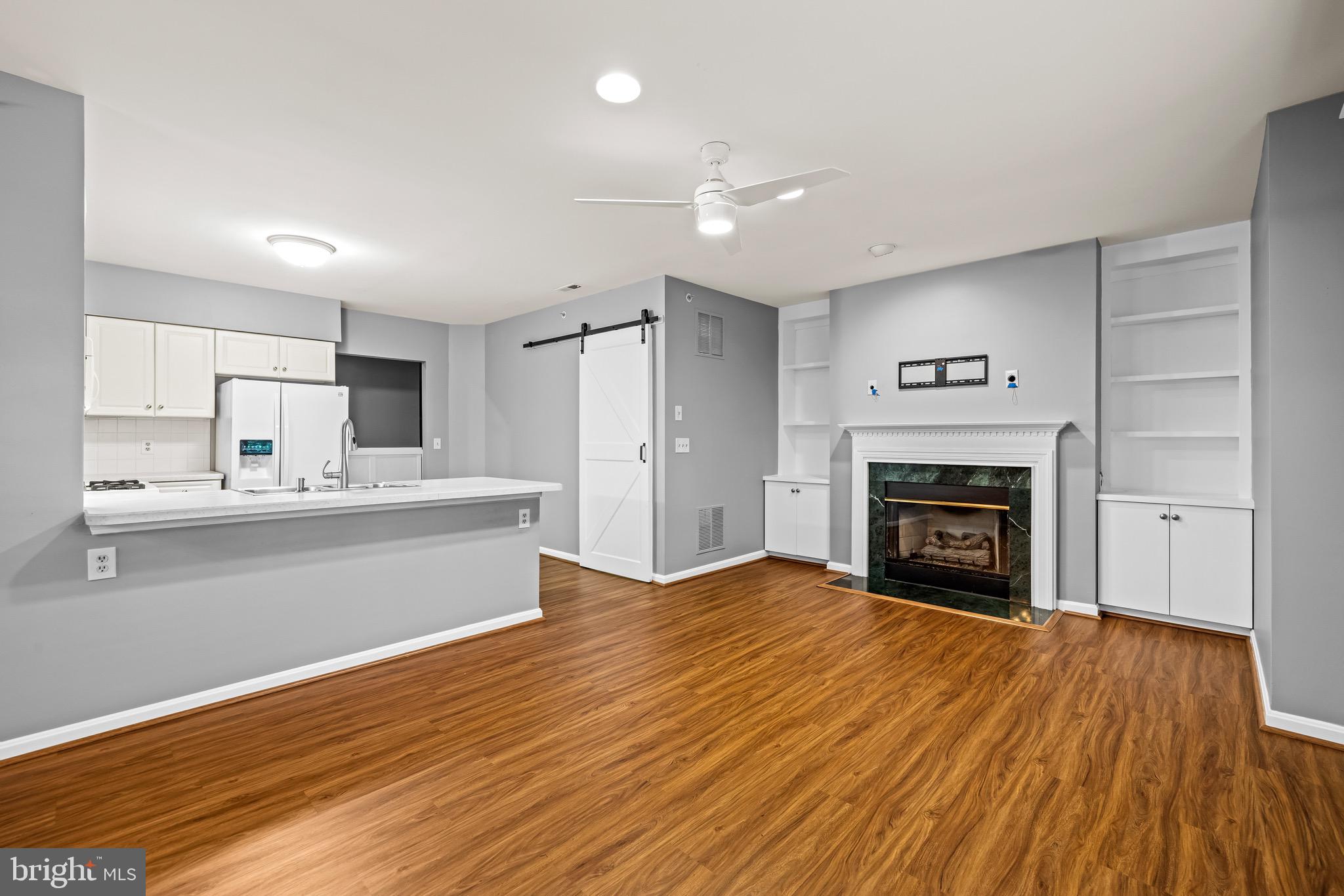 12204 Burncourt Road, Unit 302 Lutherville-Timonium, MD 21093 - Photo 7 of 27 a view of kitchen with granite countertop cabinets and wooden floor